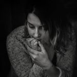 photo of a woman biting her fingernails who is anxious
