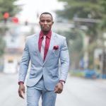man in a business suit walking down a city street